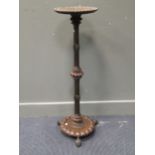 A torchere with “ivory” button decoration 102cm high and 31cm diameter top