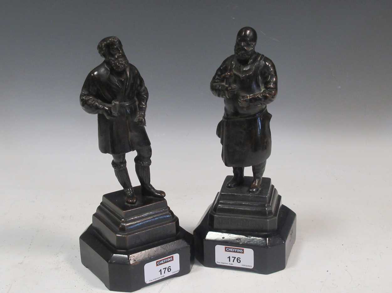 A pair of small bronze figures of artisans, on wooden socles