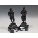 A pair of small bronze figures of artisans, on wooden socles