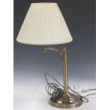 A modern brass adjustable table lamp, with shade