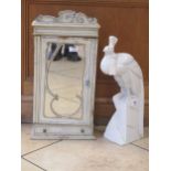 An Art Nouveau style white painted cabinet with single mirrored cupboard door over a single long
