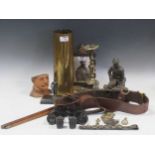 A collection of militaria, including leather ammunition pouch and belt, statues of soldiers,