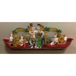 A South East Asian painted wood carving of a courting couple on a boat scene, 100 x 40cm