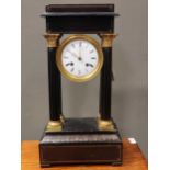 A French 19th century ebonised portico clock, of typical form, with gridiron pendulum