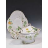 A Continental porcelain two-handled tureen, cover and stand, painted with a bird and frog amongst