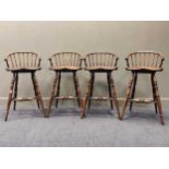 A set of 4 stick back bar stools with elm sets raised on four turned legs and stretchers 96 x 50 x