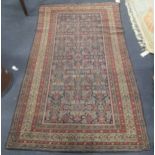 A Feraghan rug with stylised foliate motifs on a blue ground, with ivory ground main border and