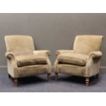 A pair of armchairs upholstered in animal print material