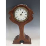 An Art Nouveau mahogany and inlaid cased mantle clock