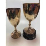 Two silver trophy cups, 27.8ozt, together with a silverplated 5 light candelabrum (3)