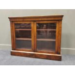 A continental walnut bookcase enclosed by glazed doors 93 x 122 x 30cm