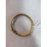 A floral hinged bangle, tested to at least 14ct gold, weight 17.1g