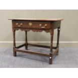 An oak side table, 18th century, the rectangular top above a single long frieze drawer with shaped