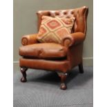 A leather button upholstered armchair