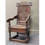 A carved oak wainscot chair containing 17th century elements