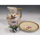 A continental porcelain jug decorated with a bird, a Limoges blush ivory plate painted with flowers,