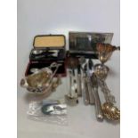 A collection of silver flatware, together with condiments, cream jugs etc and two cheese knives with