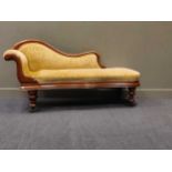 A late 19th/ early 20th century walnut chaise longue with a serpantine front raised on turned legs