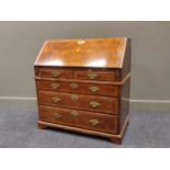 A Mid-18th century figured walnut bureau the interior with pigeon holes, fitted drawers and