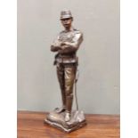 A 20th century bronze of a French soldier, signed, and a composite pedestal