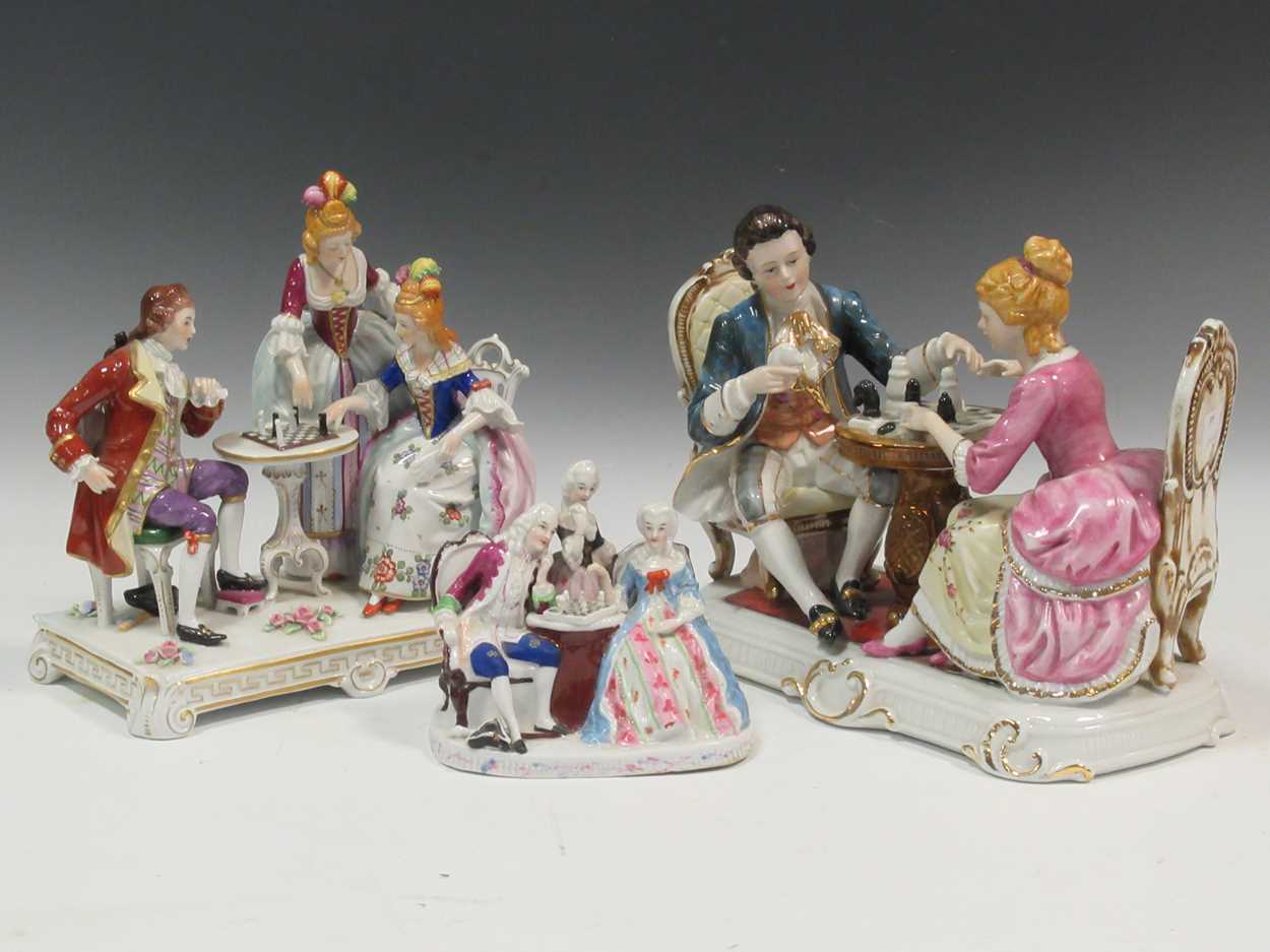 Three Continental porcelain models of figures in antique dress playing chess (3)