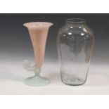 A pink and milk glass cornucopia vase and another large clear glass vase with traces of original