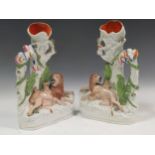 A pair of late 19th century Staffordshire flat back spill vases, modelled as a lion and lioness with