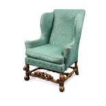 A William & Mary style wingback armchair, 19th century,