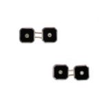 A pair of onyx and diamond cufflinks,