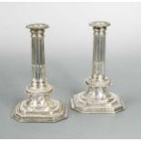 A pair of William III cast Britannia silver candlesticks,