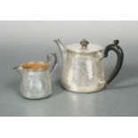 A Victorian silver teapot and milk jug, mark of Robert Garrard II,
