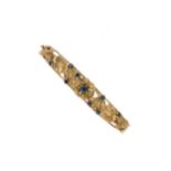 A late 20th century sapphire hinged bangle,