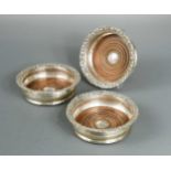 A matching trio of George III silver bottle coasters,