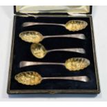 Four George III 18th century silver tablespoons with later decoration and a sifting spoon en suite,