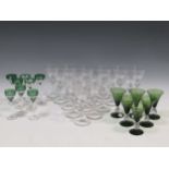 A set of 17 wine glasses, 20th century, with flattened knopped stems; A set of 8 green overlay glass