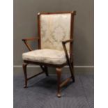 A mahogany frame highback easy armchair on cabriole legs and stretchers, early 20th century