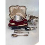 A cased silver spoon and two handled bowl, together with a silver milk jug, a pair of silver sugar