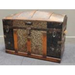 An dome top metal and wooden banded trunk, decorated with floral paper relief, with fitted tray to