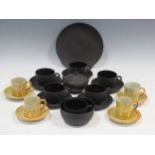 Four Cantagalli yellow lustre tea cups and saucers together with a Wedgwood basalt part tea
