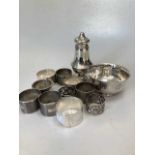 A collection of silverware including napkin rings, bowl and caster with loaded base, 14.3ozt gross