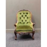 A Victorian walnut button back chair upholstered in green fabric on cabriole legs