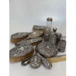 A collection of silver backed dressing tableware together with some silver topped cosmetic jars