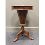 A Victorian walnut trumpet work table, the octagonal hinged lid over a tapered trumpet support