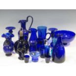 A collection of Bristol blue glassware, including jugs, vases and bowls