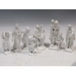 Five KPM white glazed porcleain figures; two other German white glazed figures