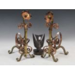 A pair of Art and Crafts brass and copper andirons, and a bird pattern bookend