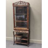 A Chinese naturalistic hard wood cabinet on stand, the upper section with single glazed door and the