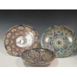 Three Moroccan plates, each decorated with fanciful geometric pattern, largest 39cm diameter (3)