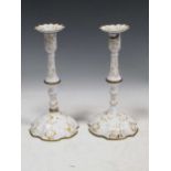 A pair of 18th century Bilston or Battersea enamel candlesticks, 28cm highSevere damage to the