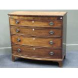 A George III bow fronted chest of drawers with graduated long drawers rasied on bracket feet, 100.